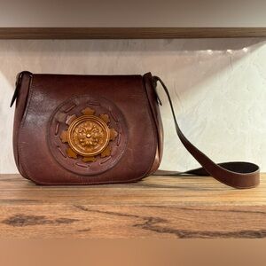 Vintage genuine leather medallion satchel. Beautiful 😍